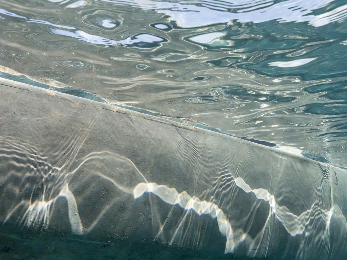 Clear Ocean Water Ripples Over Underwater Hull Coating Surface